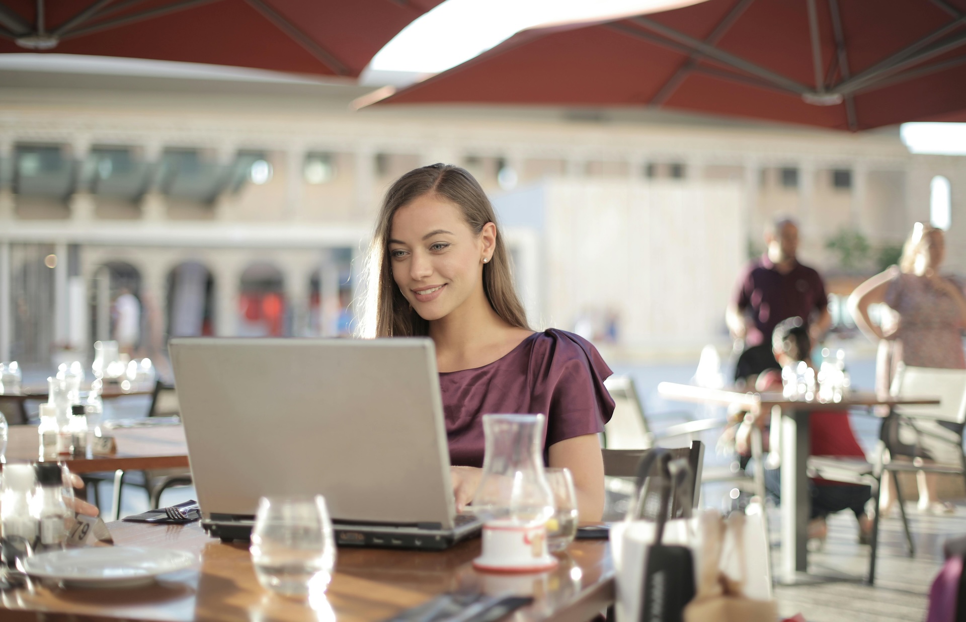 woman using laptop at restaurant