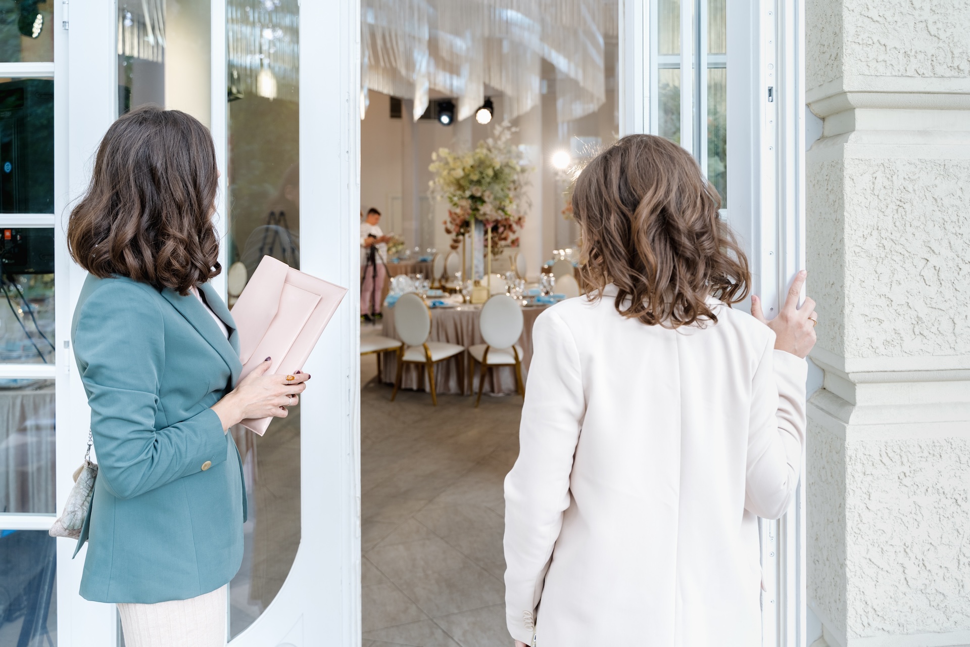 Girls in stylish suits at entrance to restaurant