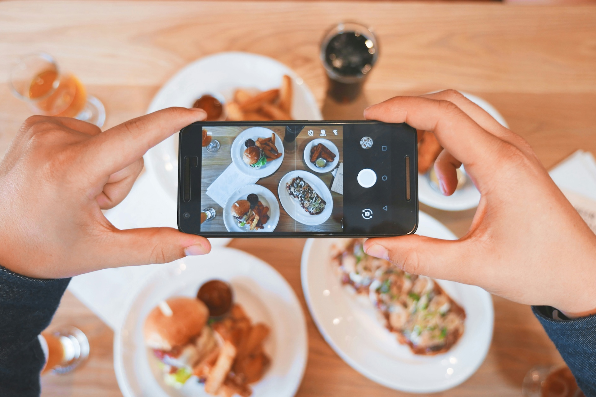 person taking picture of foods to market a restaurant
