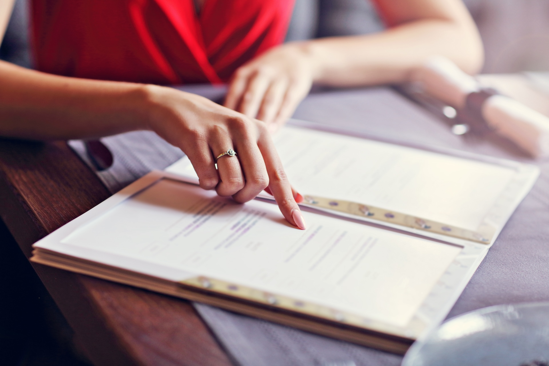 restaurant manager reviewing menu to decide which items to 86